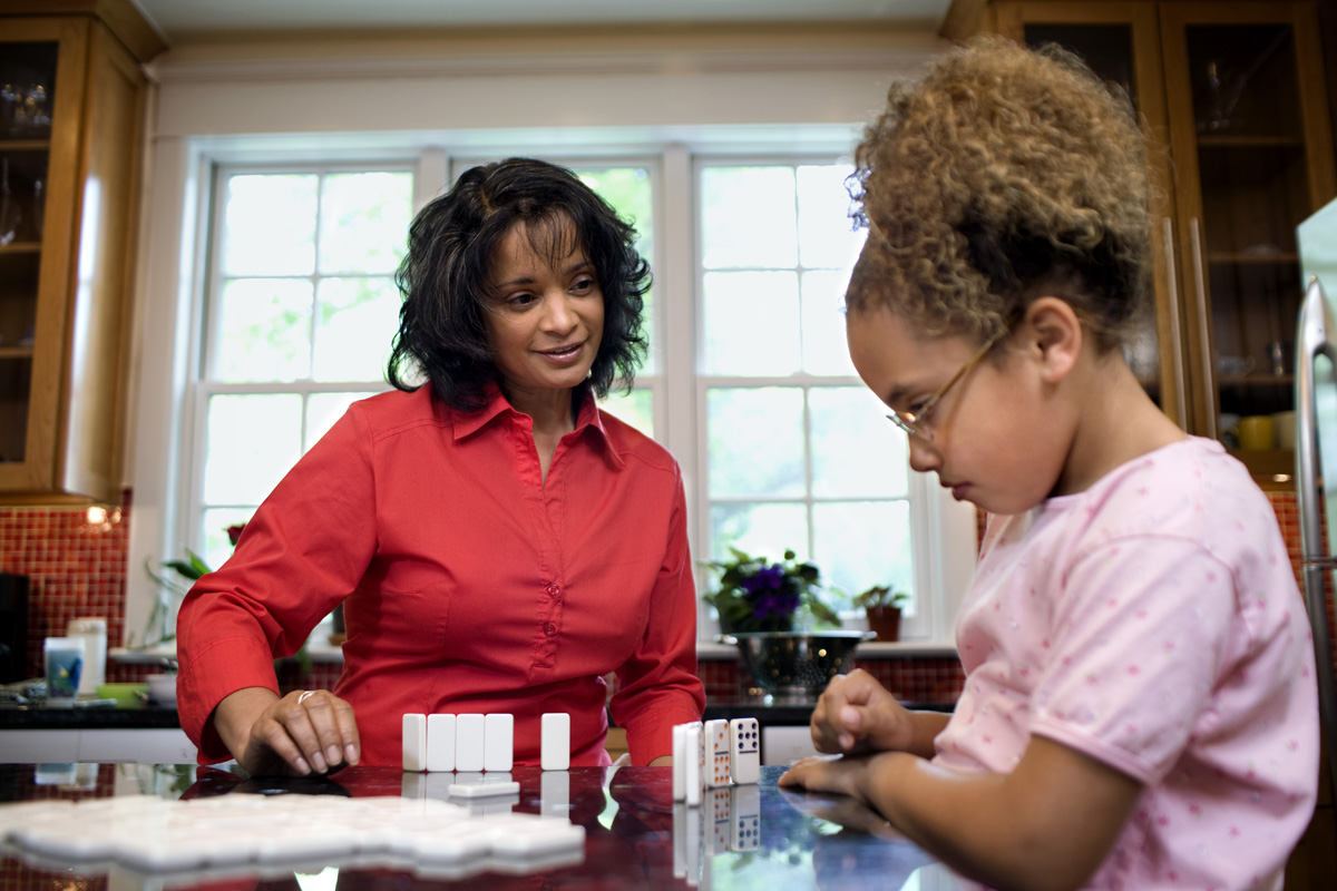 Women and child playing dominoes