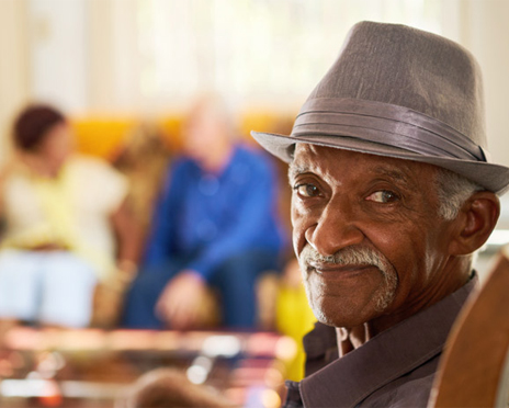 An elderly gentleman smiling and looking at the camera